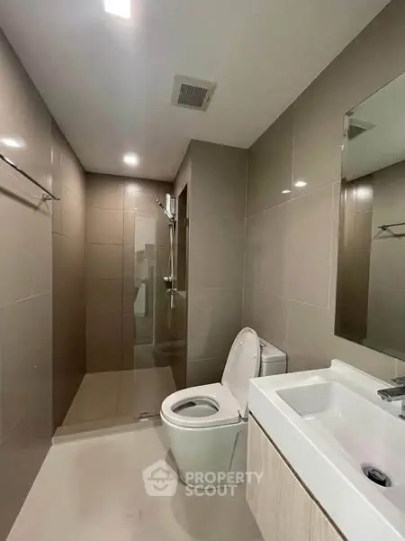 Modern bathroom with sleek fixtures and spacious shower area