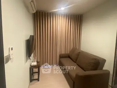 Cozy living room with brown sofa and wall-mounted TV, perfect for relaxation.