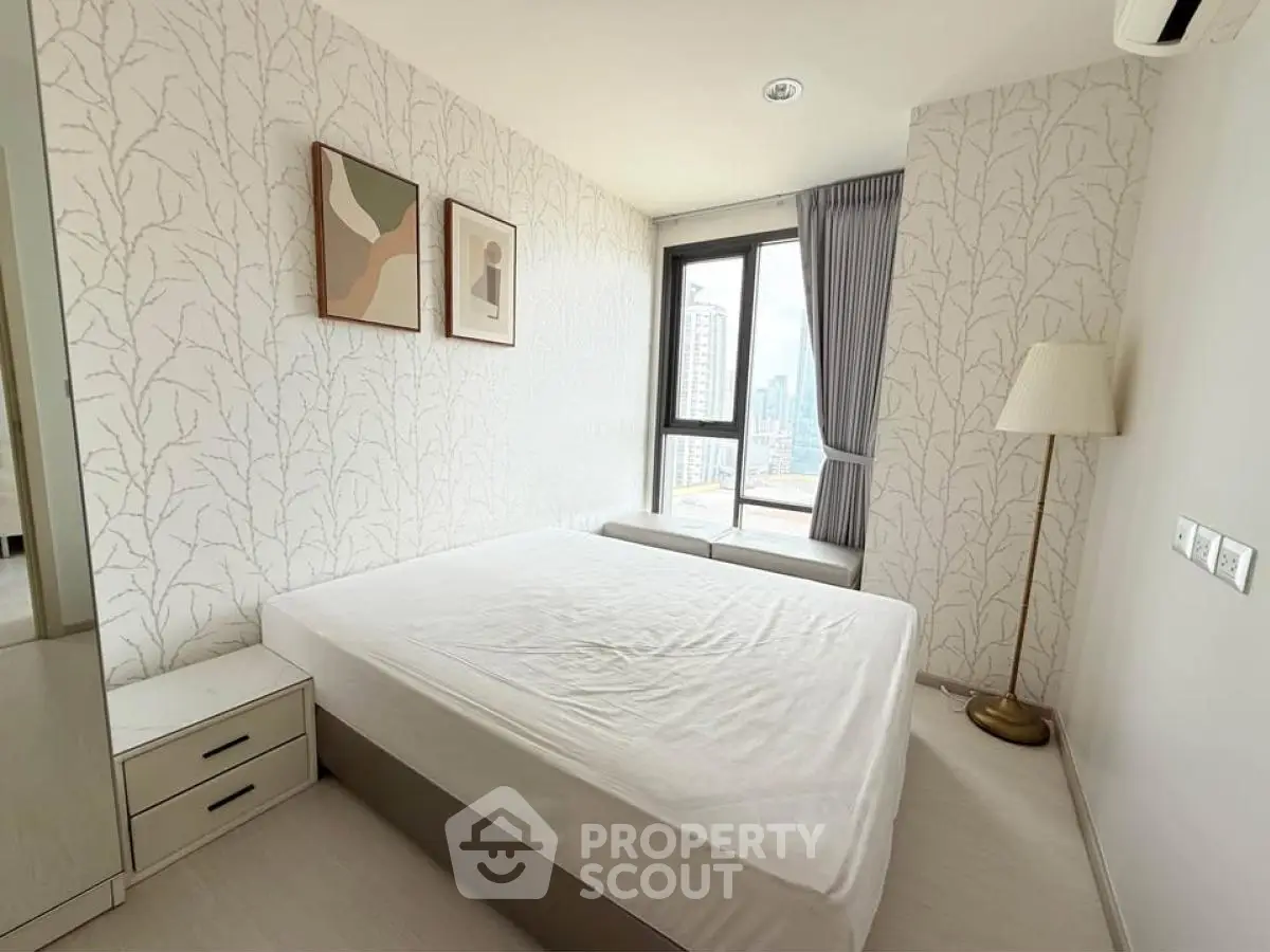 Modern bedroom with large window and stylish decor in urban apartment