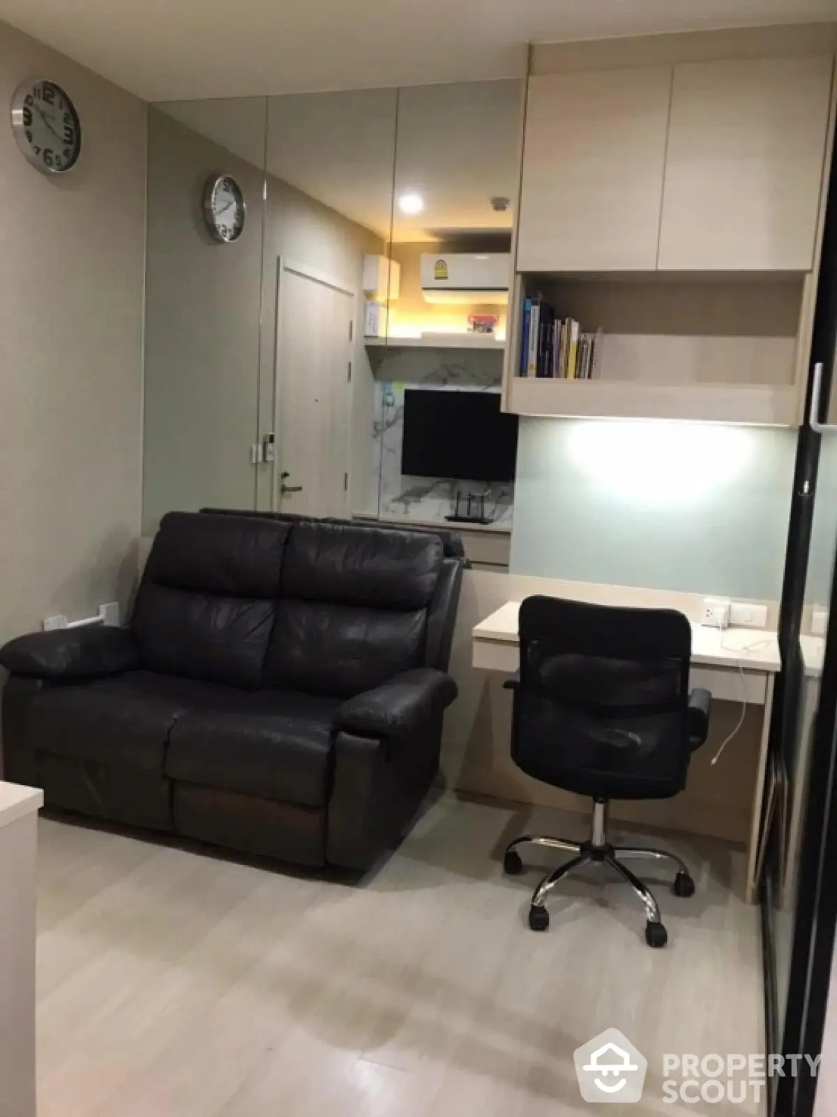 Modern study area with leather chair and built-in desk in stylish apartment