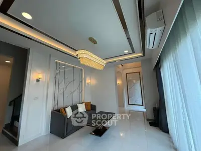 Luxurious modern living room with elegant chandelier and stylish decor