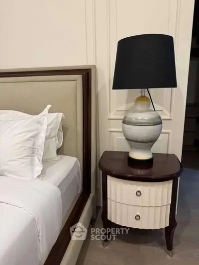 Elegant bedroom with stylish lamp and luxurious bedding