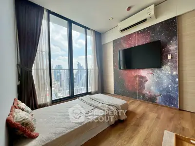 Modern bedroom with stunning city view and large window, featuring a unique galaxy-themed wall design.