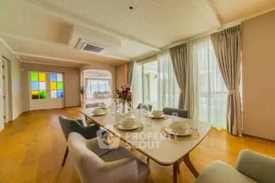 Spacious dining area with elegant decor and large windows in modern home