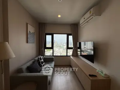 Modern living room with city view, featuring sleek furniture and air conditioning.