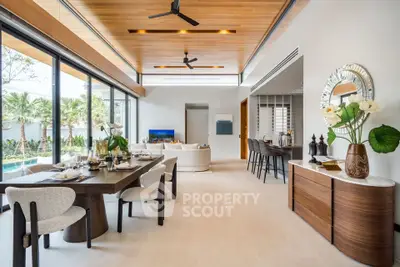 Luxurious open-plan living and dining area with pool view and modern decor