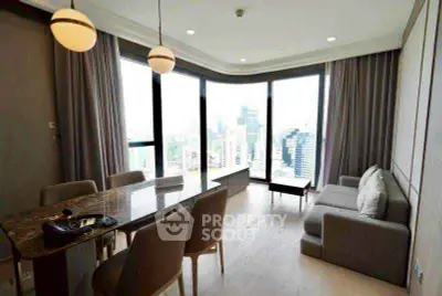 Modern living room with panoramic city view and elegant dining area.