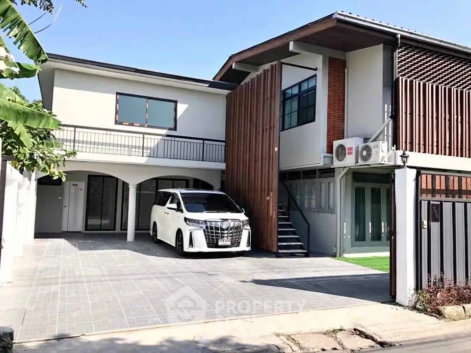Modern two-story house with spacious driveway and sleek design