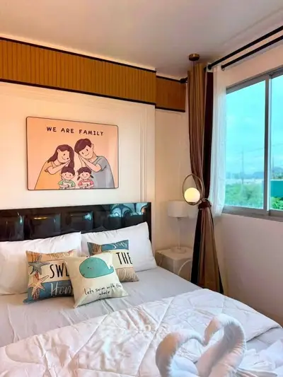Cozy bedroom with large window and family-themed decor, perfect for a warm and inviting atmosphere.