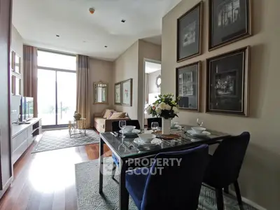 Elegant living room with dining area, featuring stylish decor and large windows for natural light.