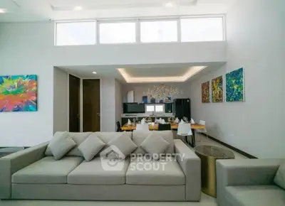 Spacious modern living room with elegant dining area and artistic decor