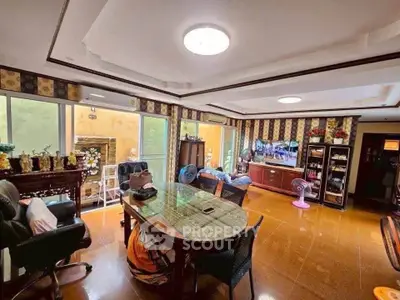 Spacious living room with modern decor and ample natural light, perfect for family gatherings.