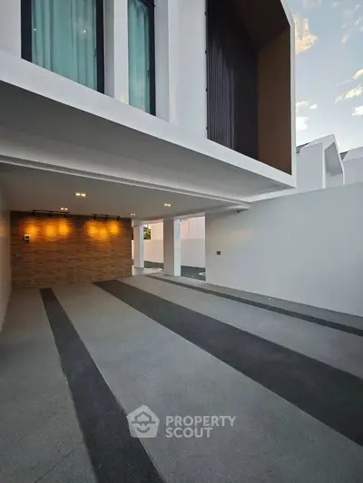 Modern minimalist building entrance with sleek design and ambient lighting