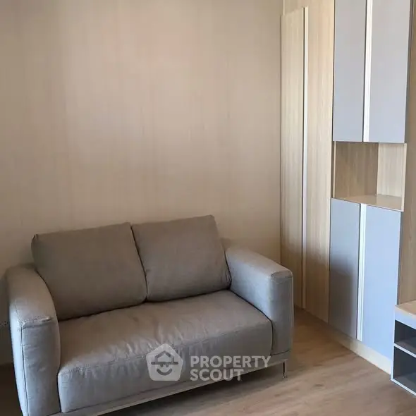 Cozy living room with modern sofa and built-in storage solutions.