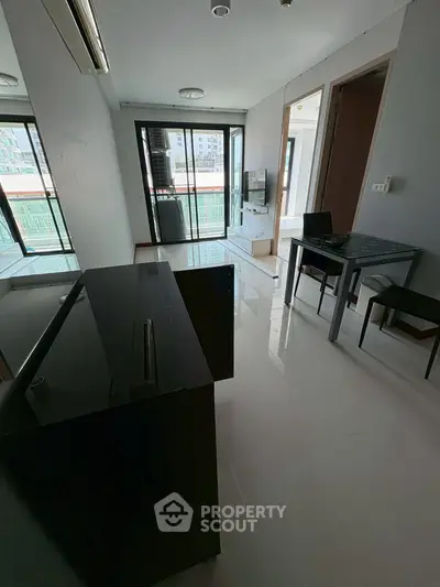 Modern living room with sleek furniture and balcony view in urban apartment