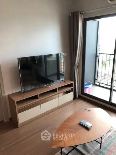 Modern living room with sleek TV setup and balcony view