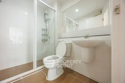 Modern bathroom with glass shower and sleek fixtures in a contemporary home.