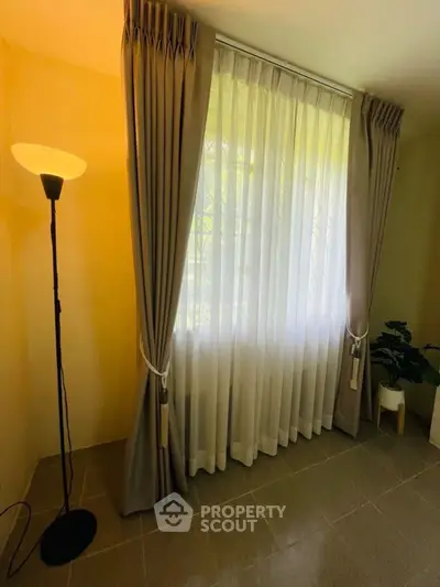 Elegant living room corner with floor lamp and stylish curtains