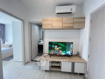 Modern living room with air conditioning and TV, adjacent to bedroom and bathroom.