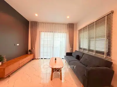 Modern living room with sleek furniture and large windows for natural light.