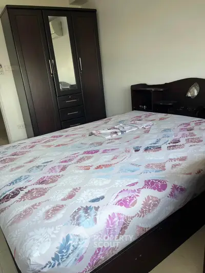 Spacious bedroom with elegant wardrobe and cozy bed in modern apartment.