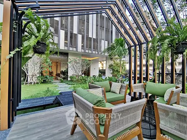 Luxurious outdoor seating area with lush greenery and modern architecture
