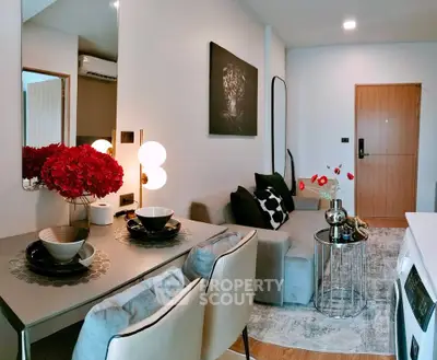 Modern living room with stylish decor and dining area in a cozy apartment.