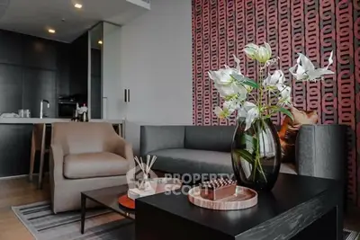 Modern living room with stylish decor and open kitchen layout, featuring elegant furniture and contemporary design.