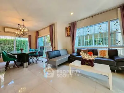 Spacious living room with modern decor and large windows offering natural light.