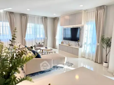 Luxurious modern living room with elegant decor and large windows