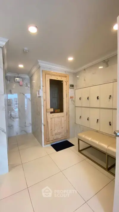 Luxurious sauna room with lockers and elegant seating in a modern spa facility.