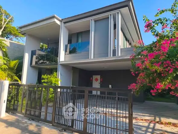 Modern two-story house with sleek design and lush garden, perfect for contemporary living.