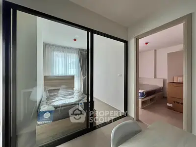 Modern apartment with two bedrooms featuring glass partition and natural light