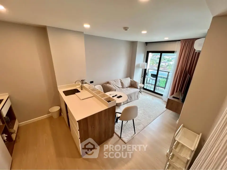 Modern open-plan living room with balcony view and stylish furniture