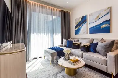 Luxurious living room with modern decor, plush sofa, and large window for natural light.