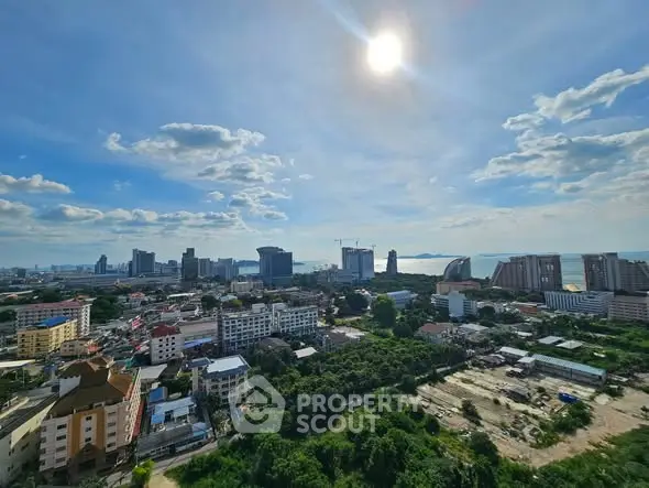 Stunning cityscape view with skyline and ocean horizon under a bright sun