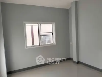 Minimalist empty room with window and neutral walls, perfect for customization.