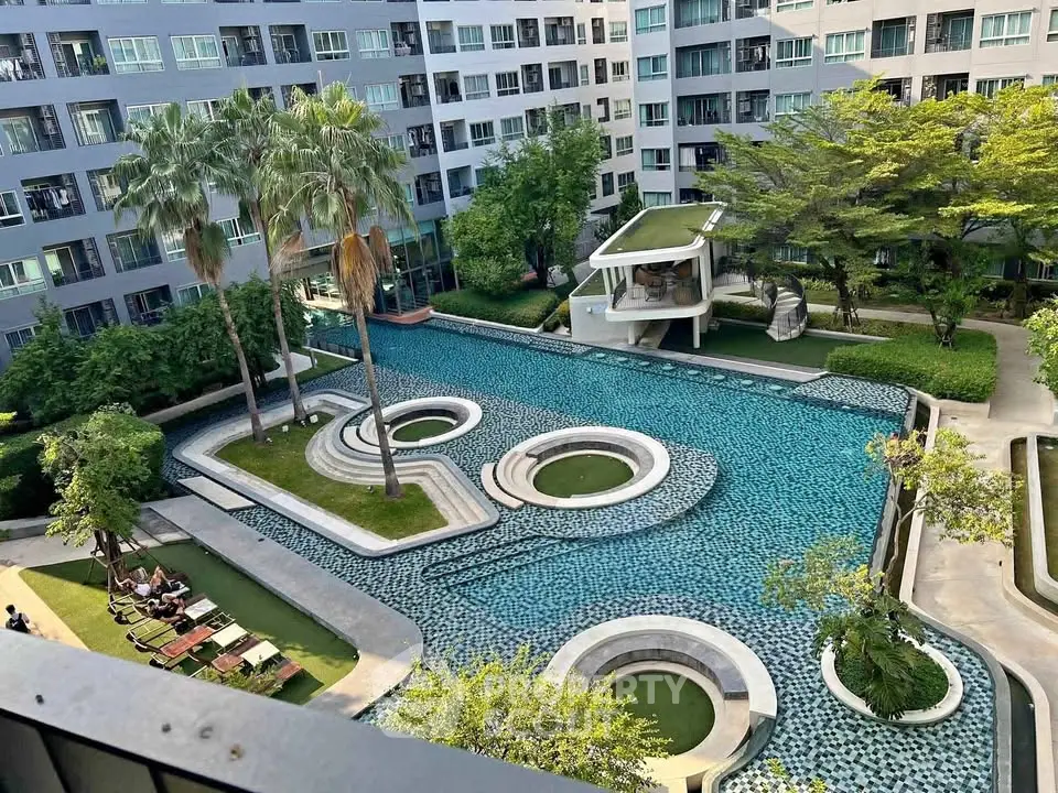 Luxurious condominium with stunning pool and lush garden view, perfect for relaxation and leisure.