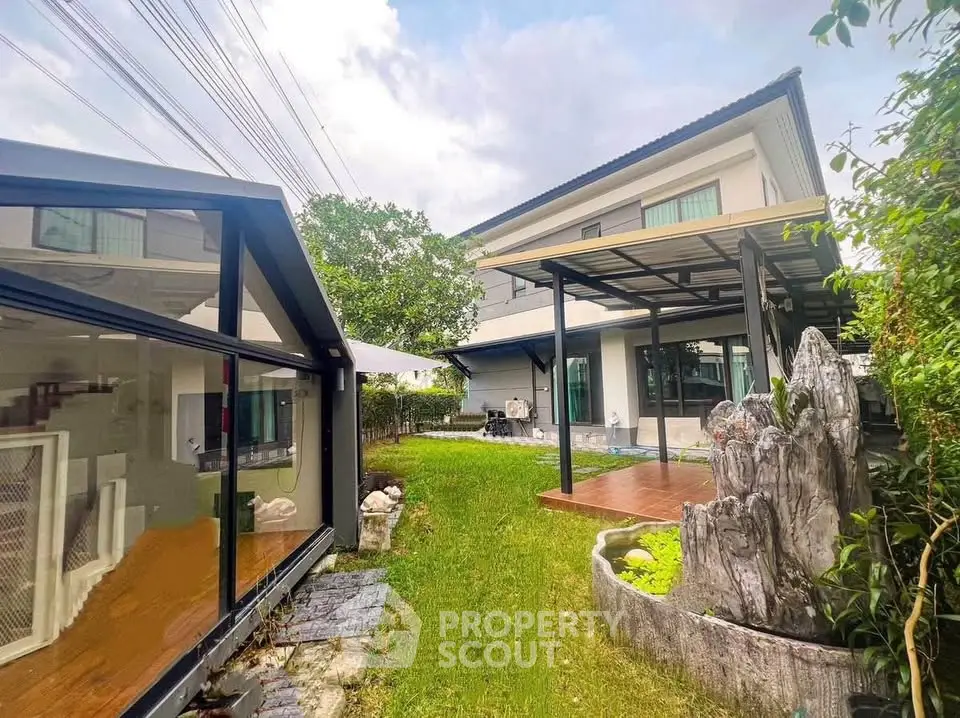 Spacious modern home with lush garden and stylish outdoor patio, perfect for family living.