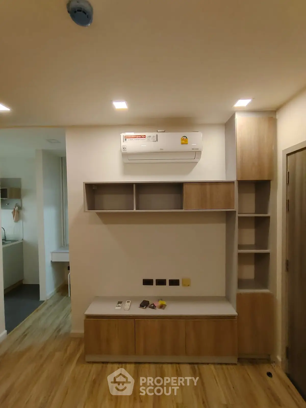 Modern living room with built-in shelves and air conditioning unit