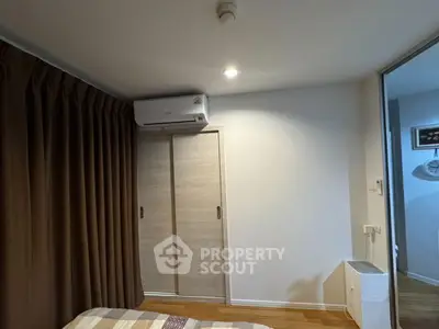 Cozy bedroom with air conditioning and sliding closet doors