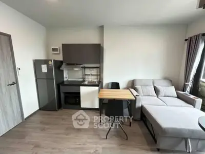 Modern compact living room with kitchenette and stylish furniture