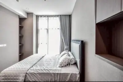 Modern bedroom with elegant decor and natural light in a stylish apartment.