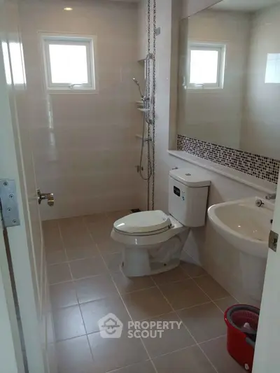 Modern bathroom with sleek fixtures and large mirror in a real estate property.