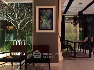 Elegant modern living room with large windows and stylish decor, perfect for entertaining.