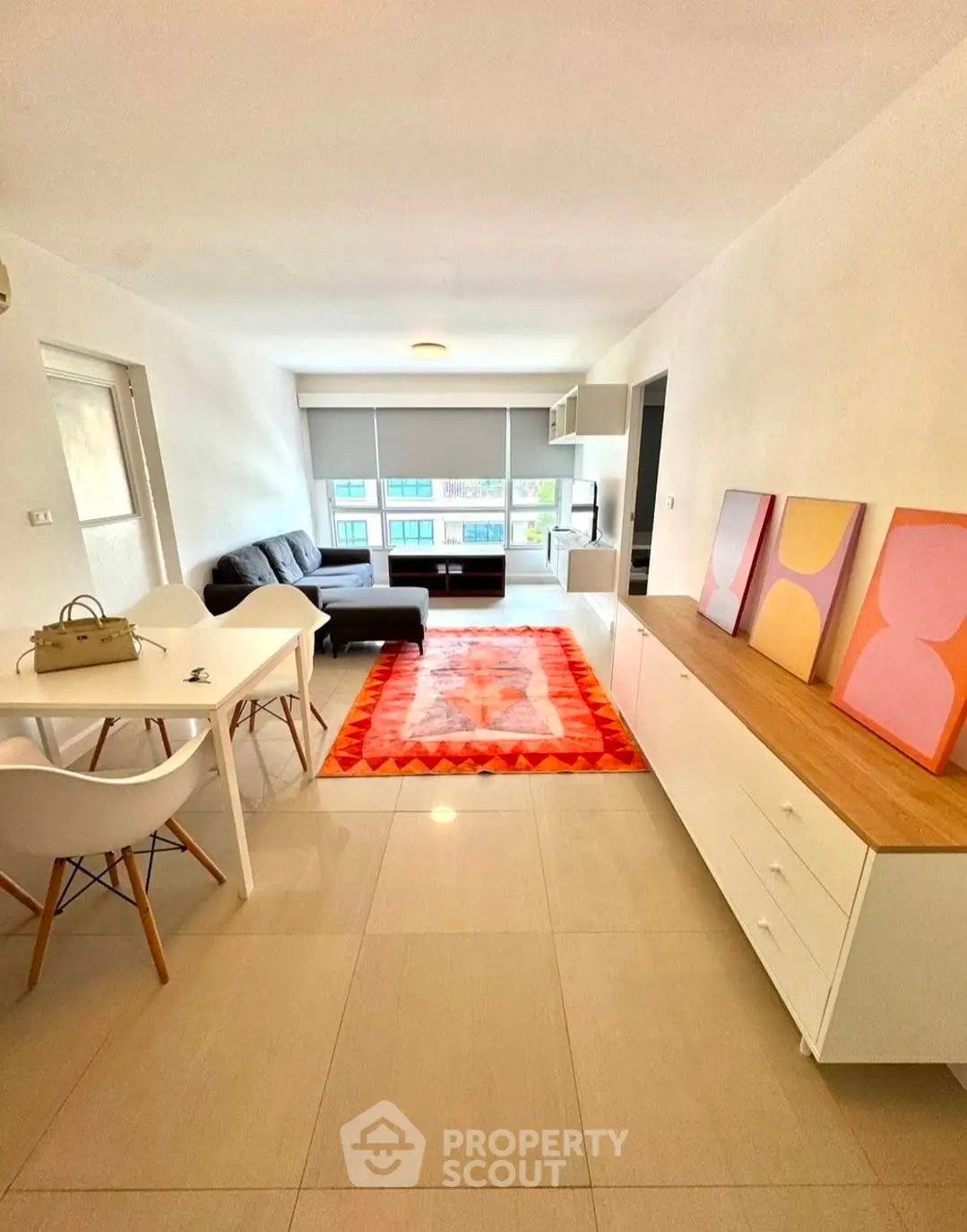 Modern living room with stylish decor and vibrant rug in a bright apartment