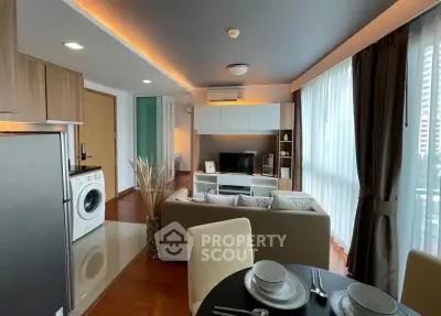 Modern living room with open kitchen and washing machine in stylish apartment