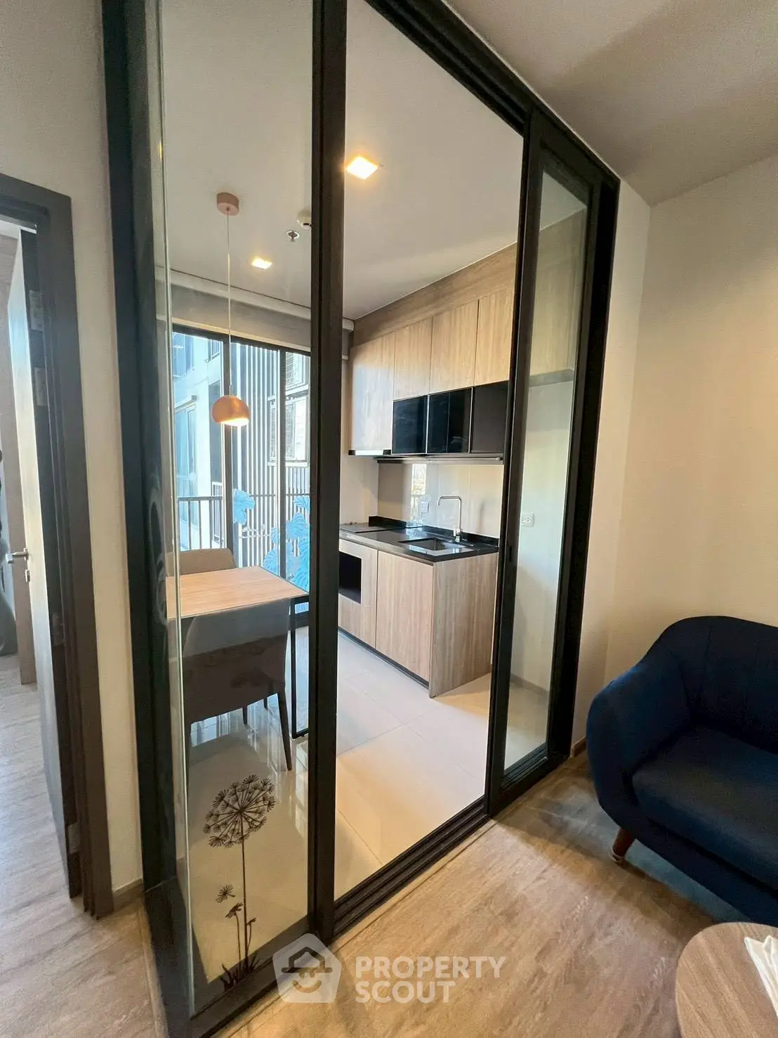 Modern kitchen with closed layout and sleek wooden cabinetry in a stylish apartment.