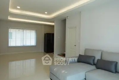 Spacious modern living room with sleek sofa and large window