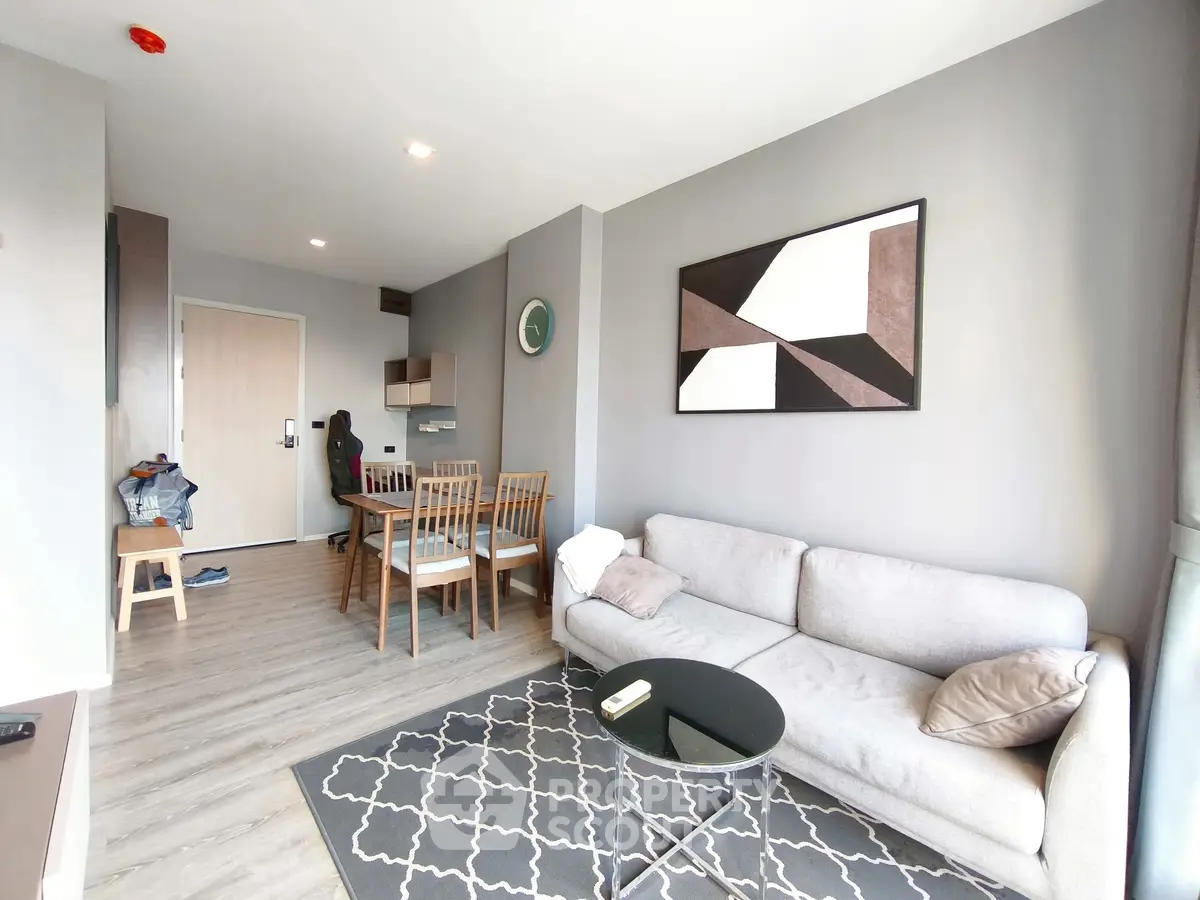 Modern living room with stylish decor and dining area in open layout apartment.